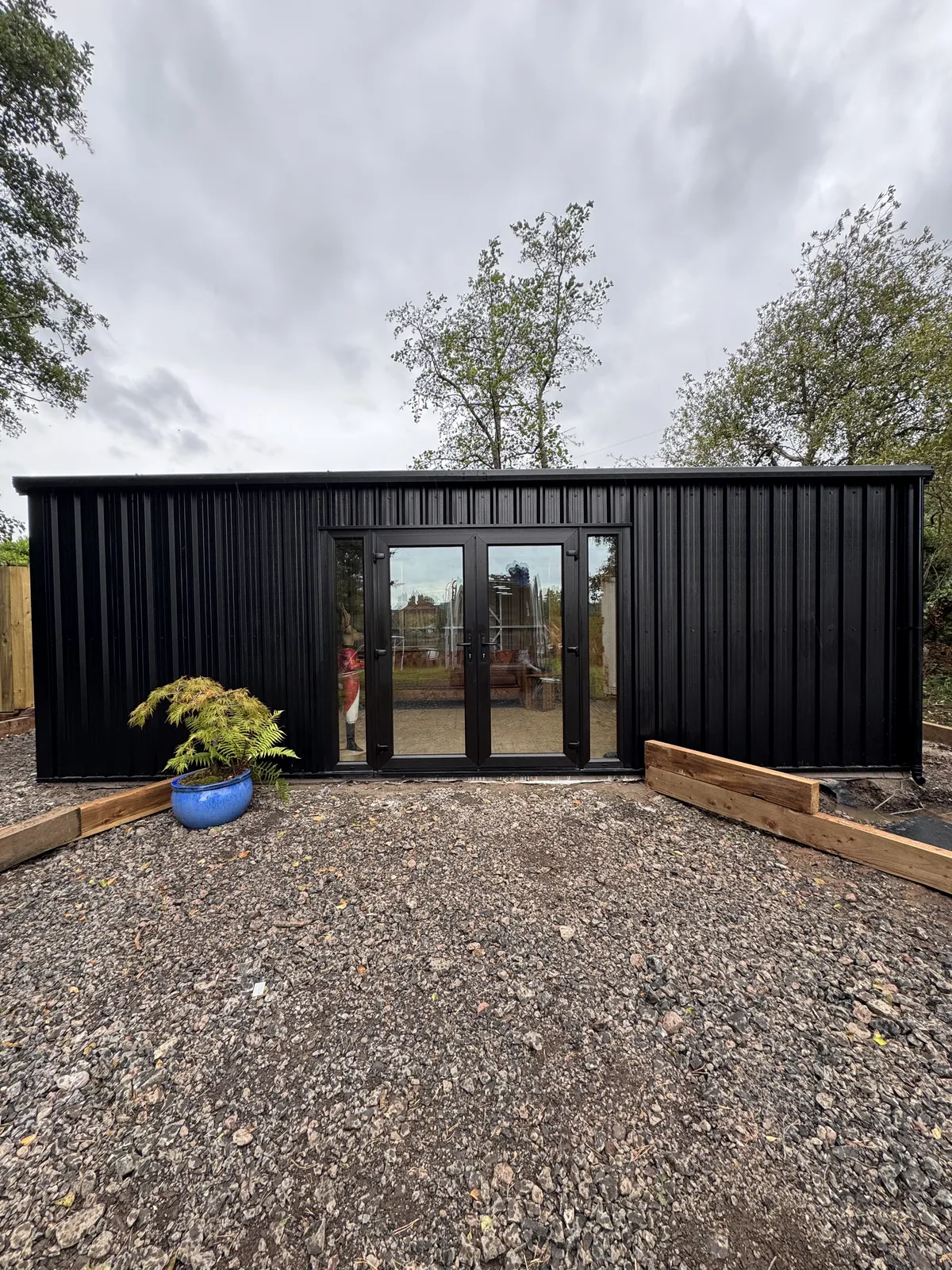 Black steel shed with French doors, front view